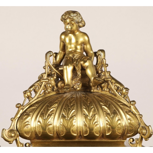50 - Antique square brass mantel clock, classical ornamentation with putti sat atop and faces on all side... 