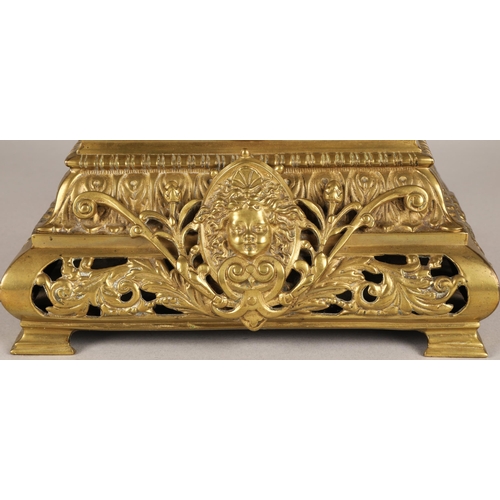 50 - Antique square brass mantel clock, classical ornamentation with putti sat atop and faces on all side... 