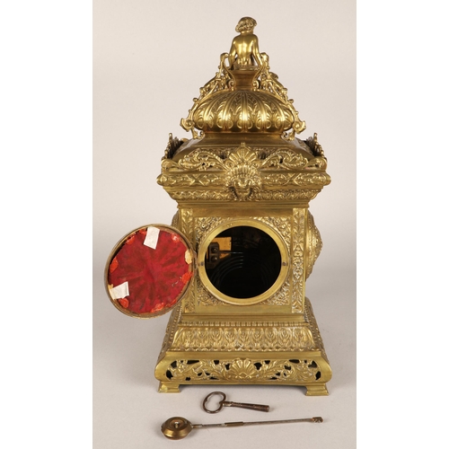50 - Antique square brass mantel clock, classical ornamentation with putti sat atop and faces on all side... 