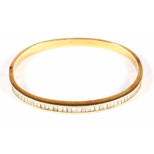 14ct yellow gold white baguette cut stone set snap shut bangle, 19.4g.