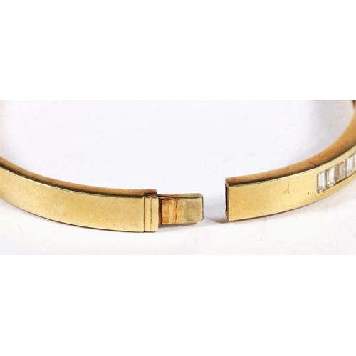 14ct yellow gold white baguette cut stone set snap shut bangle, 19.4g.