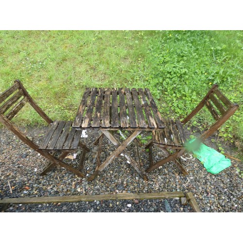 505 - Wooden garden table and two folding chairs.