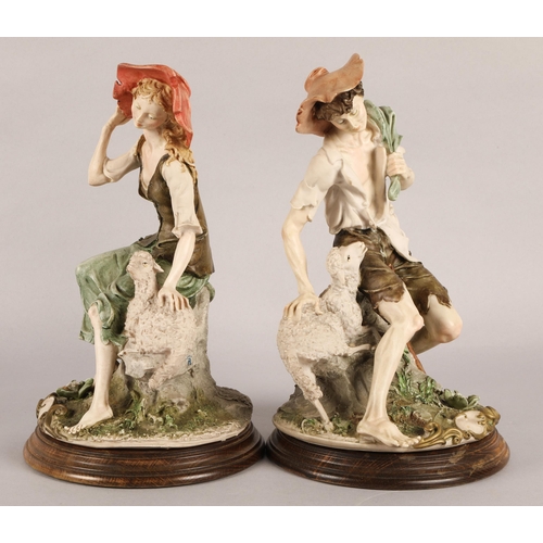 28 - Two large Capodimonte figures of a shepherd and shepherdess on wooden bases (2)