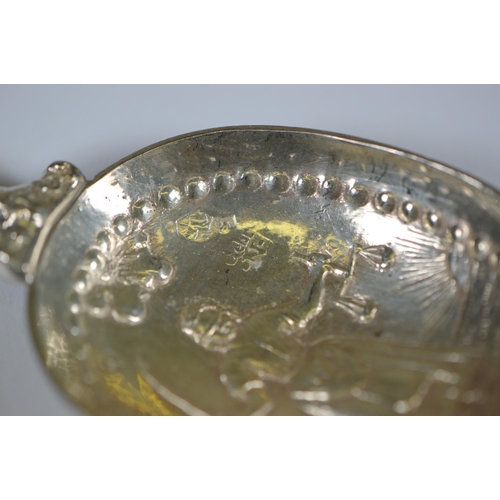 13 - Two Dutch silver spoons, c. late 19th century, with figure surmounts, embossed windmills and milkmai... 