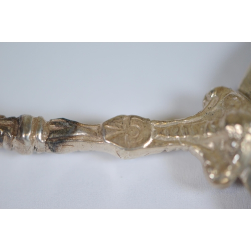 13 - Two Dutch silver spoons, c. late 19th century, with figure surmounts, embossed windmills and milkmai... 