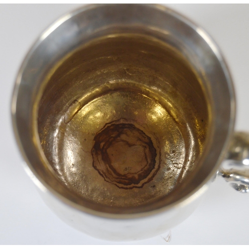 14 - George III silver tankard or pint mug of baluster form, with scroll handle, on moulded circular foot... 