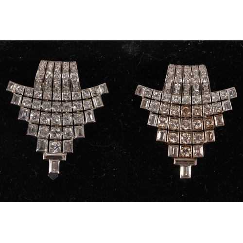 259 - Good pair of diamond set Art Deco clip brooches set in white metal, the central rows of diamonds sur... 