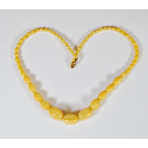 65 - String of Baltic translucent amber beads, c. early 20th century, comprising sixty-two graduated oval... 