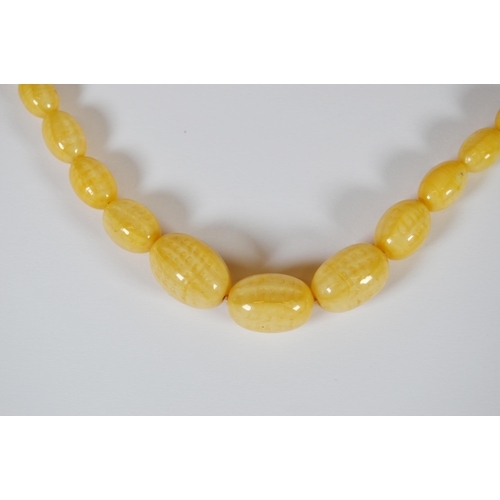 65 - String of Baltic translucent amber beads, c. early 20th century, comprising sixty-two graduated oval... 