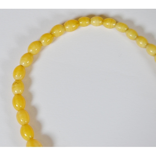 65 - String of Baltic translucent amber beads, c. early 20th century, comprising sixty-two graduated oval... 