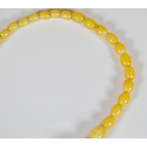 65 - String of Baltic translucent amber beads, c. early 20th century, comprising sixty-two graduated oval... 