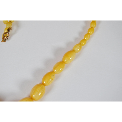 65 - String of Baltic translucent amber beads, c. early 20th century, comprising sixty-two graduated oval... 