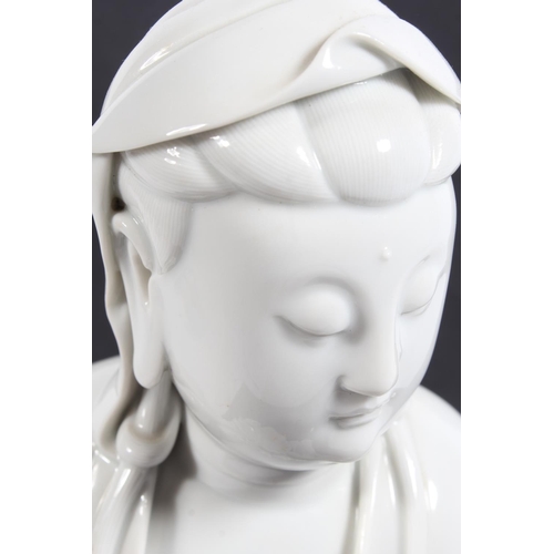 491 - Chinese blanc de chine porcelain figure of Guanyin, modelled in a seated position, 30cm tall, with o... 