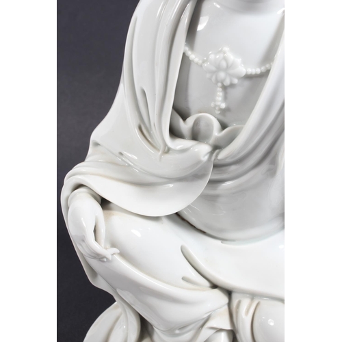 491 - Chinese blanc de chine porcelain figure of Guanyin, modelled in a seated position, 30cm tall, with o... 