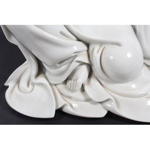 491 - Chinese blanc de chine porcelain figure of Guanyin, modelled in a seated position, 30cm tall, with o... 