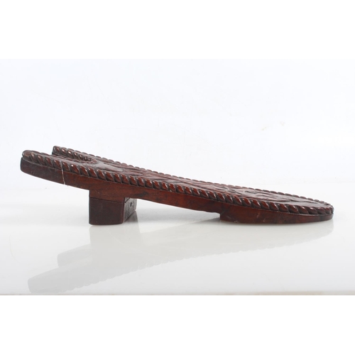 37 - Masonic interest, a carved hardwood boot jack decorated with carved floral design, the reverse with ... 