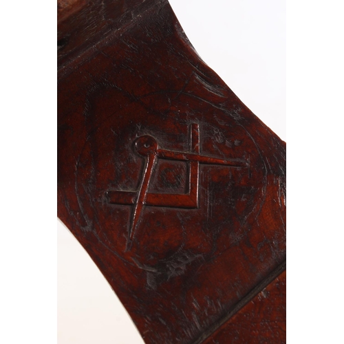 37 - Masonic interest, a carved hardwood boot jack decorated with carved floral design, the reverse with ... 