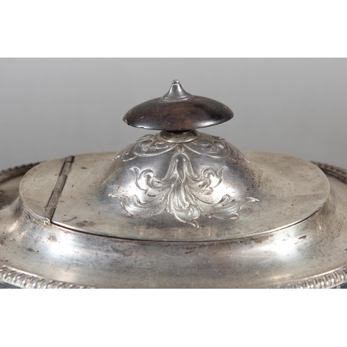 19 - Victorian silver teapot with heavily foliate decorated body and ebonised handle raised on ball suppo... 