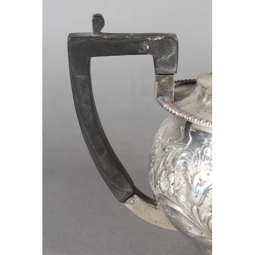 19 - Victorian silver teapot with heavily foliate decorated body and ebonised handle raised on ball suppo... 