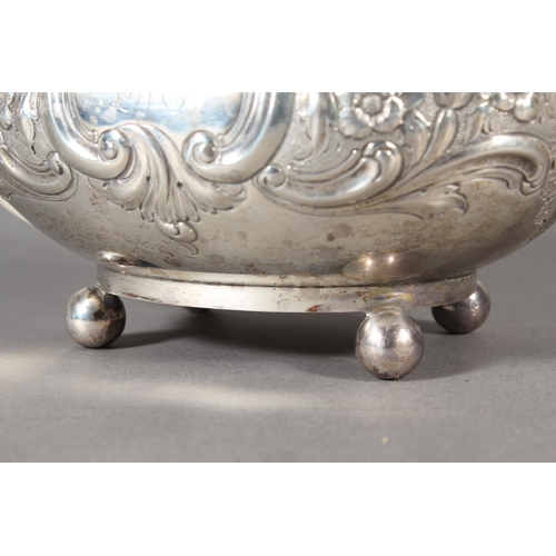 19 - Victorian silver teapot with heavily foliate decorated body and ebonised handle raised on ball suppo... 
