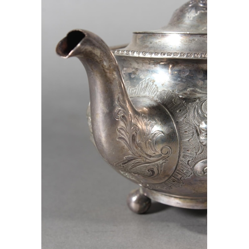 19 - Victorian silver teapot with heavily foliate decorated body and ebonised handle raised on ball suppo... 
