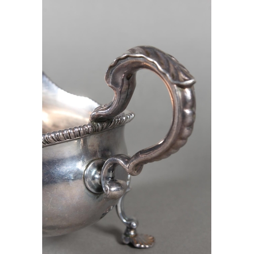 24 - Geo III silver sauce boat with gadrooned edge and raised on three shell shaped feet, Daniel Smith &a... 