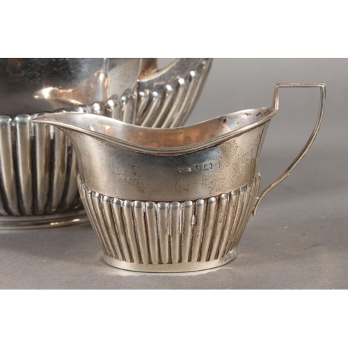 45 - Harlequin three piece silver teaset of half gadrooned form, the teapot by William Hutton & Sons ... 