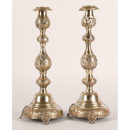 118 - Pair of George V silver candlesticks, J.R, London 1918-19, with knopped stem embossed with flowerhea... 