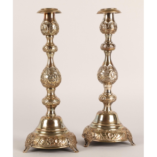 118 - Pair of George V silver candlesticks, J.R, London 1918-19, with knopped stem embossed with flowerhea... 