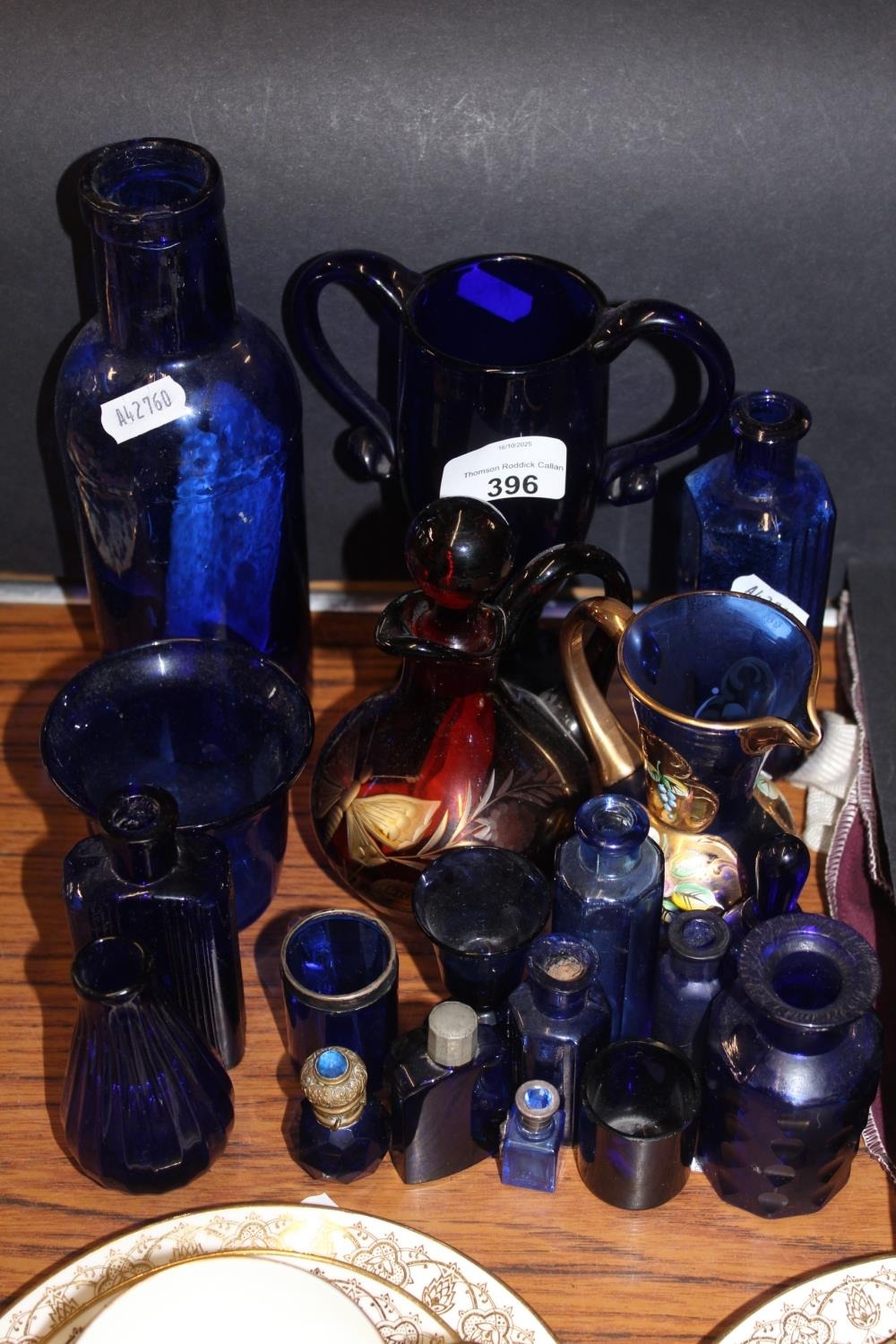 Blue glass to include perfume bottle, trophy shaped vase, etc.