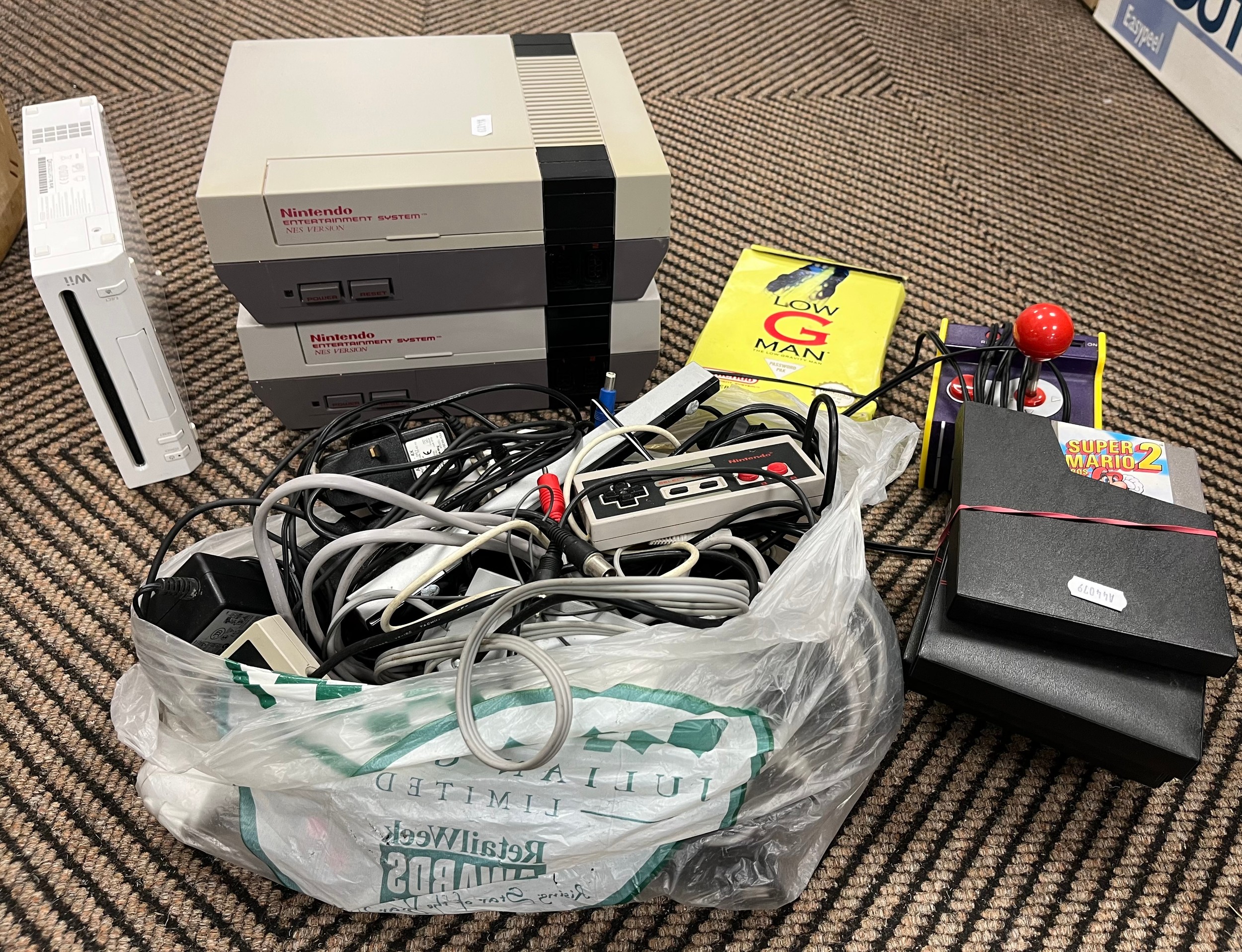 Two Nintendo Entertainment System NES game consoles and a Wii, with joy ...