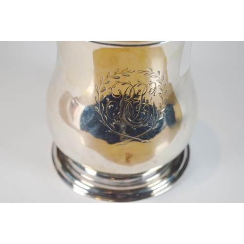 32 - Silver christening tankard of Georgian design, with flared body, engraved monogram in laurel wreath,... 