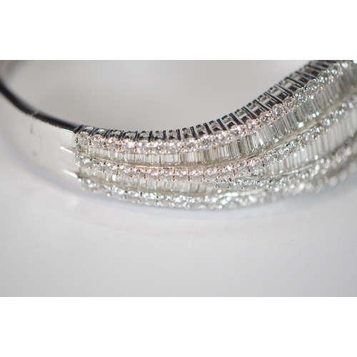 68 - Diamond hinged bangle, baguette and brilliant-cut, in white gold, 36.2g gross.