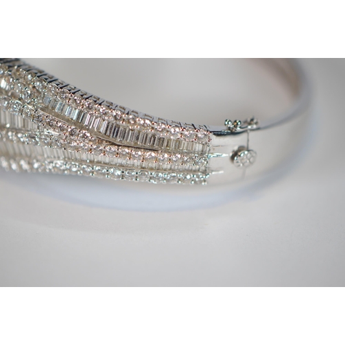 68 - Diamond hinged bangle, baguette and brilliant-cut, in white gold, 36.2g gross.