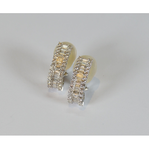 69 - Pair of diamond earrings, '18k', baguette and brilliant-cut, in white gold, stud setting, 9.7g gross... 