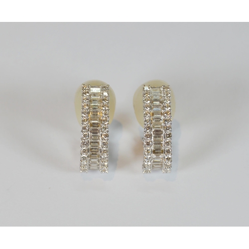69 - Pair of diamond earrings, '18k', baguette and brilliant-cut, in white gold, stud setting, 9.7g gross... 