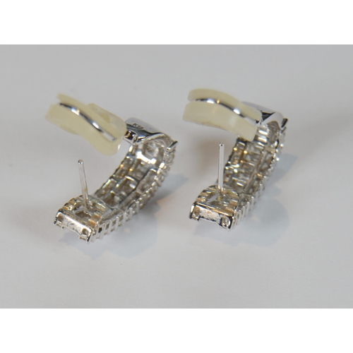 69 - Pair of diamond earrings, '18k', baguette and brilliant-cut, in white gold, stud setting, 9.7g gross... 