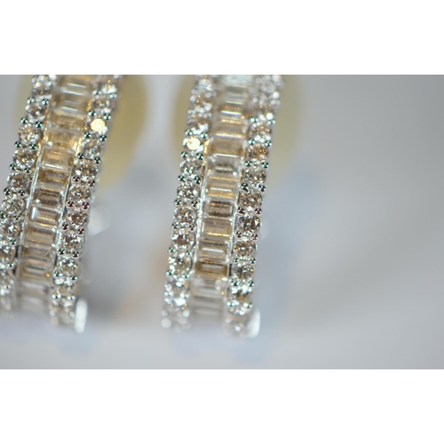 69 - Pair of diamond earrings, '18k', baguette and brilliant-cut, in white gold, stud setting, 9.7g gross... 