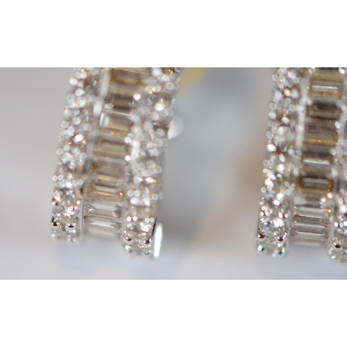 69 - Pair of diamond earrings, '18k', baguette and brilliant-cut, in white gold, stud setting, 9.7g gross... 