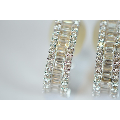 69 - Pair of diamond earrings, '18k', baguette and brilliant-cut, in white gold, stud setting, 9.7g gross... 