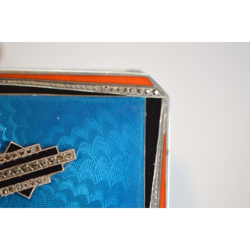 43 - Art Deco blue, orange and black enamelled silver compact containing lipstick and powder within, engi... 
