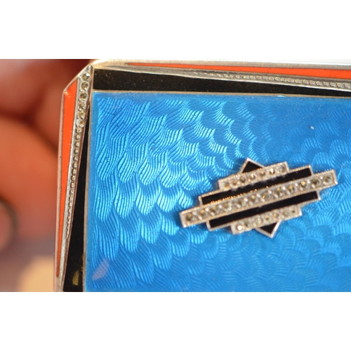43 - Art Deco blue, orange and black enamelled silver compact containing lipstick and powder within, engi... 