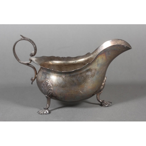53 - Silver sauce boat with wavy edged rim raised on paw supports with scrolling handle, Walker & Hal... 