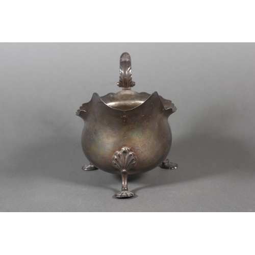 53 - Silver sauce boat with wavy edged rim raised on paw supports with scrolling handle, Walker & Hal... 