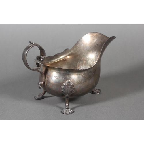 53 - Silver sauce boat with wavy edged rim raised on paw supports with scrolling handle, Walker & Hal... 