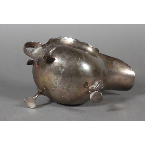 53 - Silver sauce boat with wavy edged rim raised on paw supports with scrolling handle, Walker & Hal... 