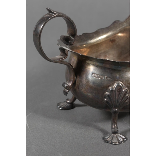 53 - Silver sauce boat with wavy edged rim raised on paw supports with scrolling handle, Walker & Hal... 