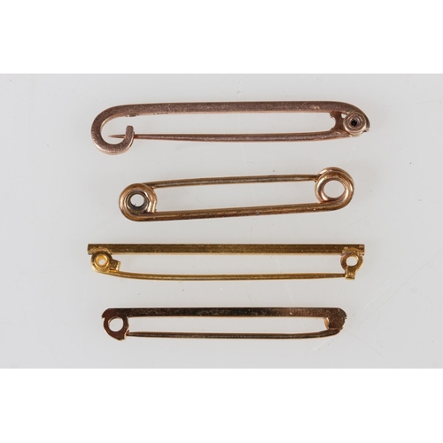 Two 9ct yellow gold brooches, 4.1g, a rolled gold stick pin and another.