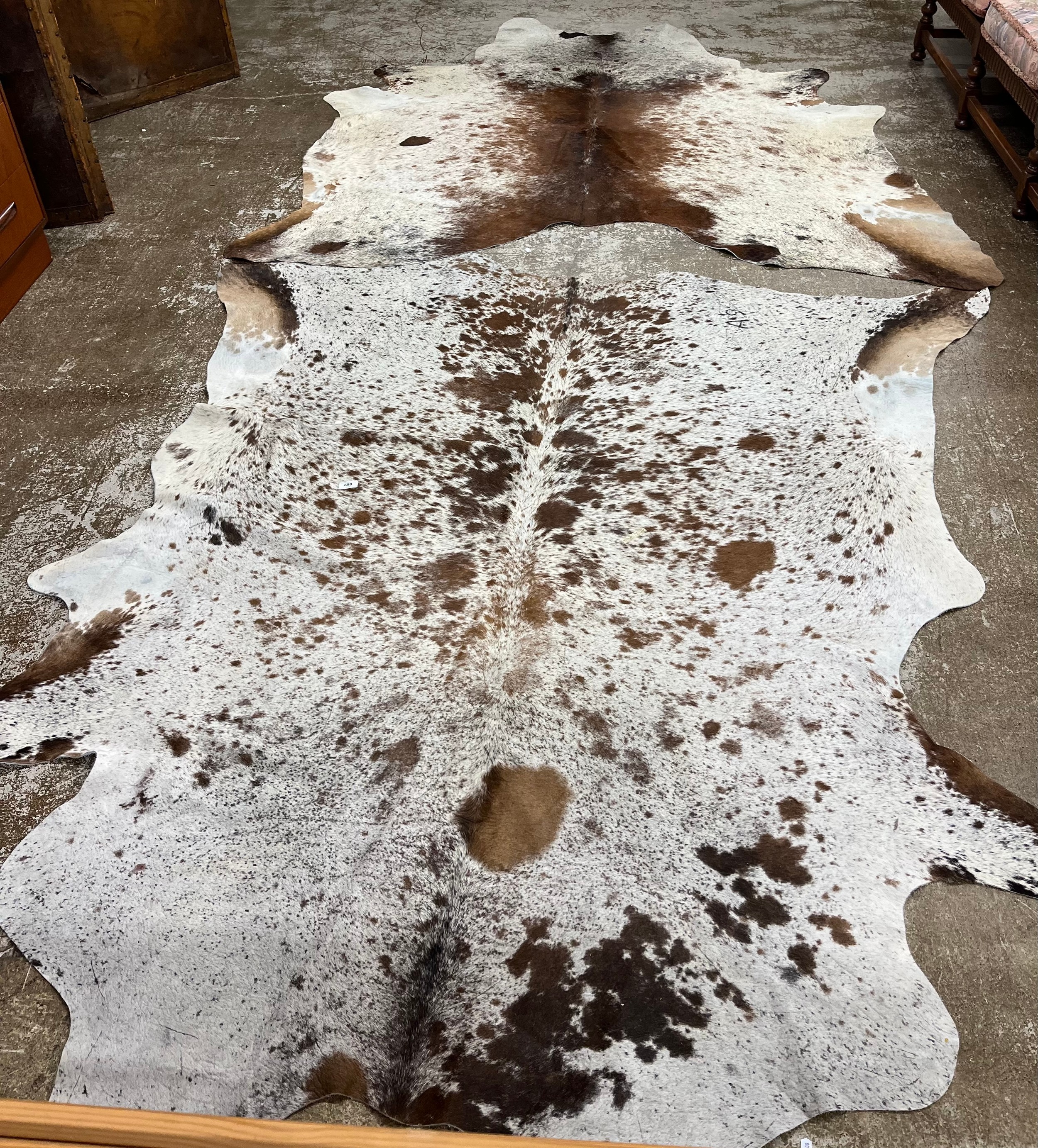 Two large cowskin rugs