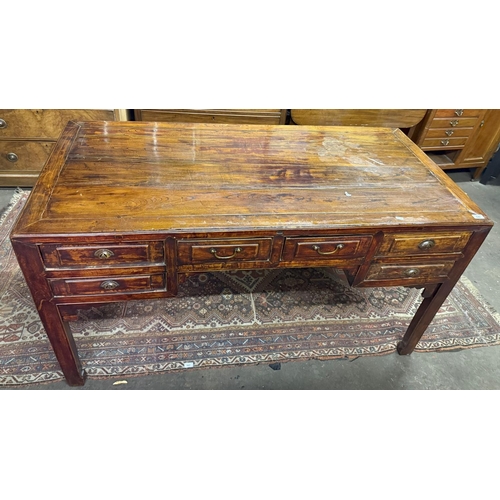378 - Antique style Chinese hardwood multi drawer partners desk with shaped skirt.